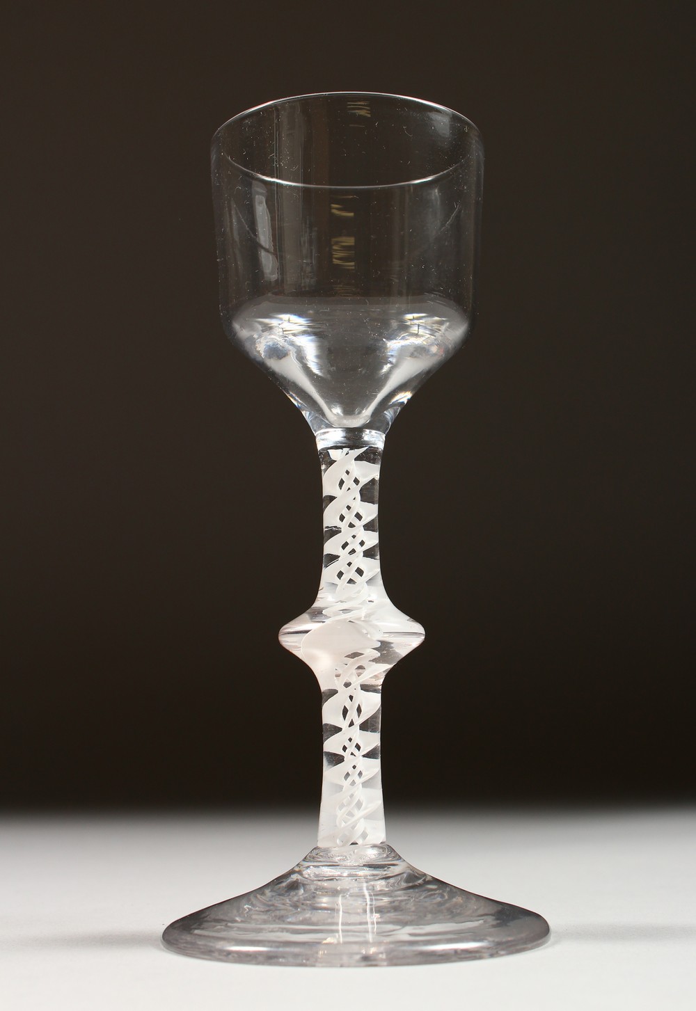 A GEORGIAN WINE GLASS, the plain bowl with knop stem and white air twist. 6ins high.