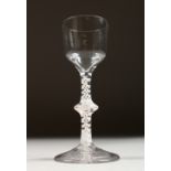 A GEORGIAN WINE GLASS, the plain bowl with knop stem and white air twist. 6ins high.