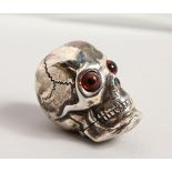 A NOVELTY SILVER SKULL.