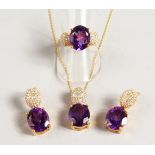 A SILVER AND GOLD PLATED THREE PIECE AMETHYST SET, pendant, earrings and ring.