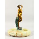 AN ART NOUVEAU GILDED BRONZE STANDING NUDE, a bird at her foot, on a circular onyx base. VRAI