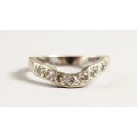 AN 18CT GOLD DIAMOND AND WISHBONE RING.