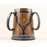 A DOULTON STONEWARE THREE HANDLED TYG with blue decoration. 7ins high.