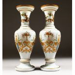 A GOOD PAIR OF 19TH CENTURY OPALINE VASES with gilt and coloured decoration. 14ins high.