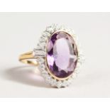 A LARGE 9CT GOLD OVAL AMETHYST AND DIAMOND RING.