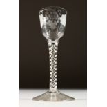 A GEORGIAN WINE GLASS, the bowl engraved with fruiting vines, with white air twist stem. 5.75ins