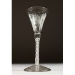 A GEORGIAN WINE GLASS with tapering bowl engraved with fruiting vines, with air twist stem. 6.5ins