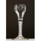 A GEORGIAN WINE GLASS, the bowl engraved with sunflowers, with white air twist stem. 5.5ins high.