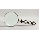 A MAGNIFYING GLASS with black and white handle.