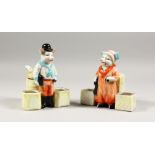 A PAIR OF CONTINENTAL PORCELAIN MR. AND MRS. PIG CRUETS.