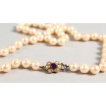 A STRING OF PEARLS with 9ct gold pearl and amethyst clasp.