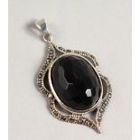 A SILVER BLACK FACET CUT STONE PENDANT.