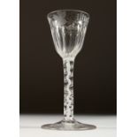 A GEORGIAN WINE GLASS, the fluted bowl engraved with flowers and butterflies, with white air twist