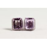 A PAIR OF SILVER SQUARE CUT AMETHYST EARRINGS.