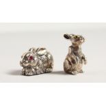 TWO SMALL CAST SILVER NOVELTY RABBITS.