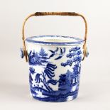 A BISTO WILLOW PATTERN DESIGN BLUE AND WHITE PAIL with lift out bowl and wicker handle. 10ins high.