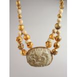 A SUPERB SILVER GILT AND CHINESE CARVED JADE NECKLACE set with a large jade pendant carved with a