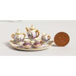 A MINIATURE LIMOGES PORCELAIN TEA SET painted with roses comprising tray, teapot, milk jug, sugar