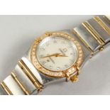 A VERY GOOD LADIES' STEEL, GOLD AND DIAMOND OMEGA WRISTWATCH. No. 57101544, with paperwork.