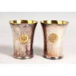 A HEAVY PAIR OF BEAKERS with silver gilt interiors. Made for the HONG KONG JOCKEY CLUB 1884 - 1984.