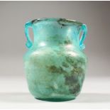 A ROMAN GLASS TWO HANDLED VASE. 4ins high.