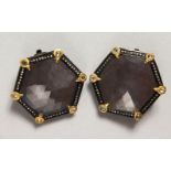 A GOOD PAIR OF 18CT GOLD OCTAGONAL BLACK STONE EAR CLIPS surrounded by small diamonds.