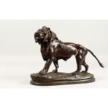 A. BARYE. A Lion Striding Out, one of a pair. Unsigned. 12ins long x 8.25ins high.