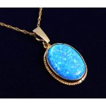 A 9CT GOLD GILSON BLACK OPAL PENDANT on a chain.