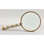 A MAGNIFYING GLASS with mother-of-pearl handle.