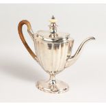 A GEORGE III FLUTED COFFEE POT with wooden handle. London 1797. Maker Jabez Davul. Weight 28ozs.