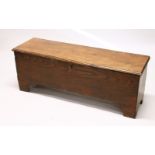 AN 18TH CENTURY ELM SIX PLANK COFFER, on bracket feet. 4ft 0ins long x 14ins wide x 1ft 6ins high.