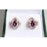 A PAIR OF 9CT GOLD AMETHYST AND DIAMOND EARRINGS.