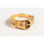 A 9CT GOLD AND DIAMOND BUCKLE RING.