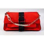 A CHRISTIAN DIOR RED BAG with chrome chain in a Dior box.