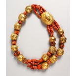 A LARGE SILVER GILT AND CORAL NECKLACE with an oval pendant, the lid opening with a beast hanging