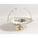 A VICTORIAN CAKE BASKET with engraved decoration and pierced swing handle. 11.5ins diameter.