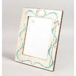 A LARGE SILVER AND ENAMEL PHOTOGRAPH FRAME. 11ins x 9ins.