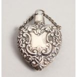 A SILVER EMBOSSED HEART SHAPED PERFUME BOTTLE.