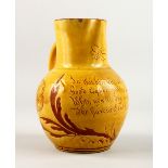 A GOOD YELLOW STONEWARE "BEE" JUG with inscription "In this time we're all alive etc." 8.5ins high.