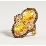 A VERY GOOD 18CT GOLD YELLOW SAPPHIRE AND DIAMOND RING.