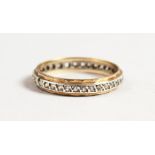 A GOLD AND DIAMOND ETERNITY RING.