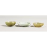 THREE SMALL JADE BOWLS. 1.5ins diameter.