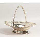 A GEORGE III OVAL PIERCED CAKE BASKET with bright cut decoration, bead edge, pierced sides and swing