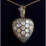 A 9CT GOLD AND SILVER MOONSTONE HEART LOCKET on a chain.