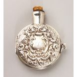 A VICTORIAN CIRCULAR FLASK with repousse decoration. 3ins diameter. London 1897. Maker W. Comyns.