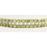 A SILVER DOUBLE ROW PERIDOT BRACELET.