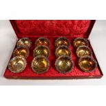 A SET OF TWELVE FRENCH SILVER FRUIT BOWLS with repousse rim. 6ins diameter in a large fitted box.