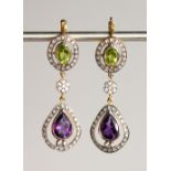 A PAIR OF 9CT GOLD AND SILVER SET SUFFRAGETTE COLOURED PERIDOT, AMETHYST AND DIAMOND DROP EARRINGS.