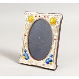 A SILVER AND ENAMEL FLOWER PHOTOGRAPH FRAME. 6ins x 4.5ins.