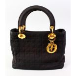 A CHRISTIAN DIOR BLACK BAG with gilt rings with dust cover.